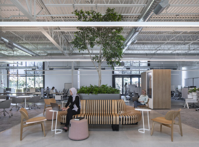 Modern office space with employees at work and casual seating areas.