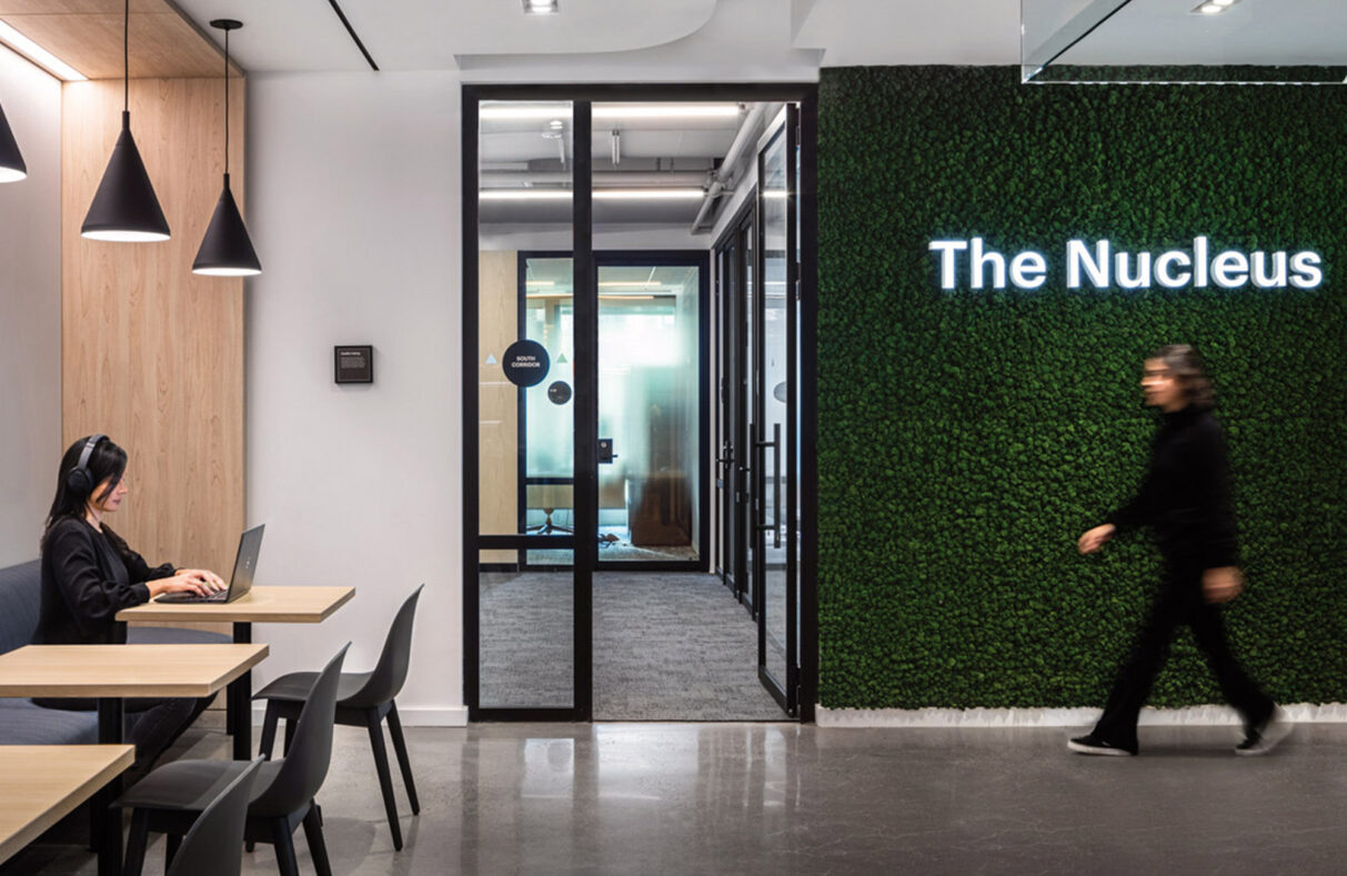 Schrodinger office lobby showing signage and green wall with neon lit sign